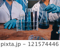 Blood test in the laboratory. Laboratory assistant working with the dispenser. Vacuum tubes with blood. 121574446