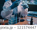 Blood test in the laboratory. Laboratory assistant working with the dispenser. Vacuum tubes with blood. 121574447