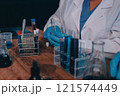 Blood test in the laboratory. Laboratory assistant working with the dispenser. Vacuum tubes with blood. 121574449