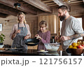 Family making pancakes, preparing sweet breakfast in the morning. 121756157