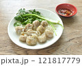 steamed fish dumpling with parsley and spring onion on plate dipping spicy sour sauce  121817779