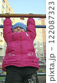 Girl hanging on horizontal bar. Funny childhood 122087323