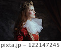 pensive medieval queen in red dress with white collar 122147245