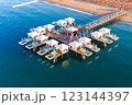 Aerial view of a luxury beach resort with exclusive overwater cabanas on a wooden pier. 123144397