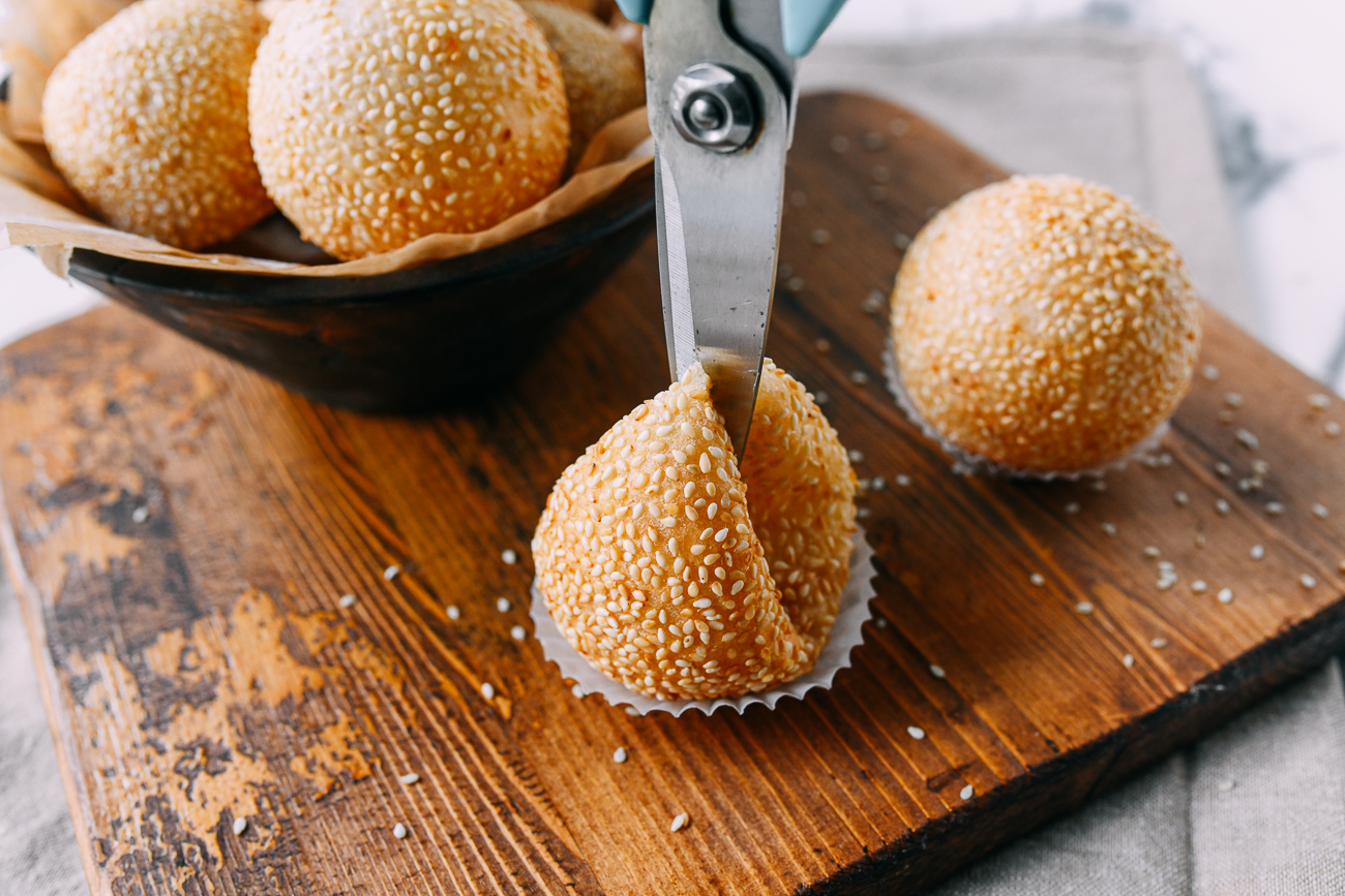 Cutting sesame ball in half with scissors