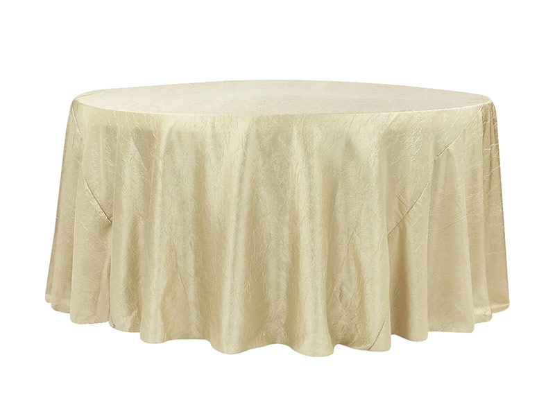 Cream colored crushed linen over table on a white background.