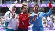 Silver medalist Uzbekistan's Kubaro Khakimova (L), gold medalist Tunisia's Raoua Tlili and bronze medalist Argentine's Antonella Ruiz Diaz celebrate on the podium during the victory ceremony for the women's F41 shot put final athletics event at the Paris 2024 Paralympic Games at Stade de France in Saint-Denis, north of Paris on August 30, 2024. Photo by JULIEN DE ROSA / AFP