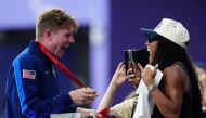 Gold medallist US' Hunter Woodhall (L) celebrates with his wife Olympic women's long jump champion Tara Davis-Woodhall after the victory ceremony for the Men's 400m T62 final event at the Stade de France in Saint-Denis, outside Paris on September 6, 2024. (Photo by Dimitar DILKOFF / AFP)