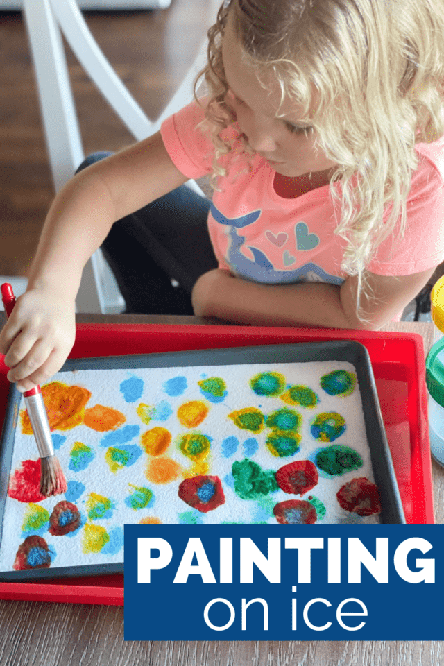 little girl painting on ice with washable paint