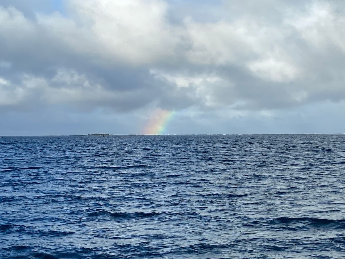 A rainbow in the distance over the ocean in Hawai’i.