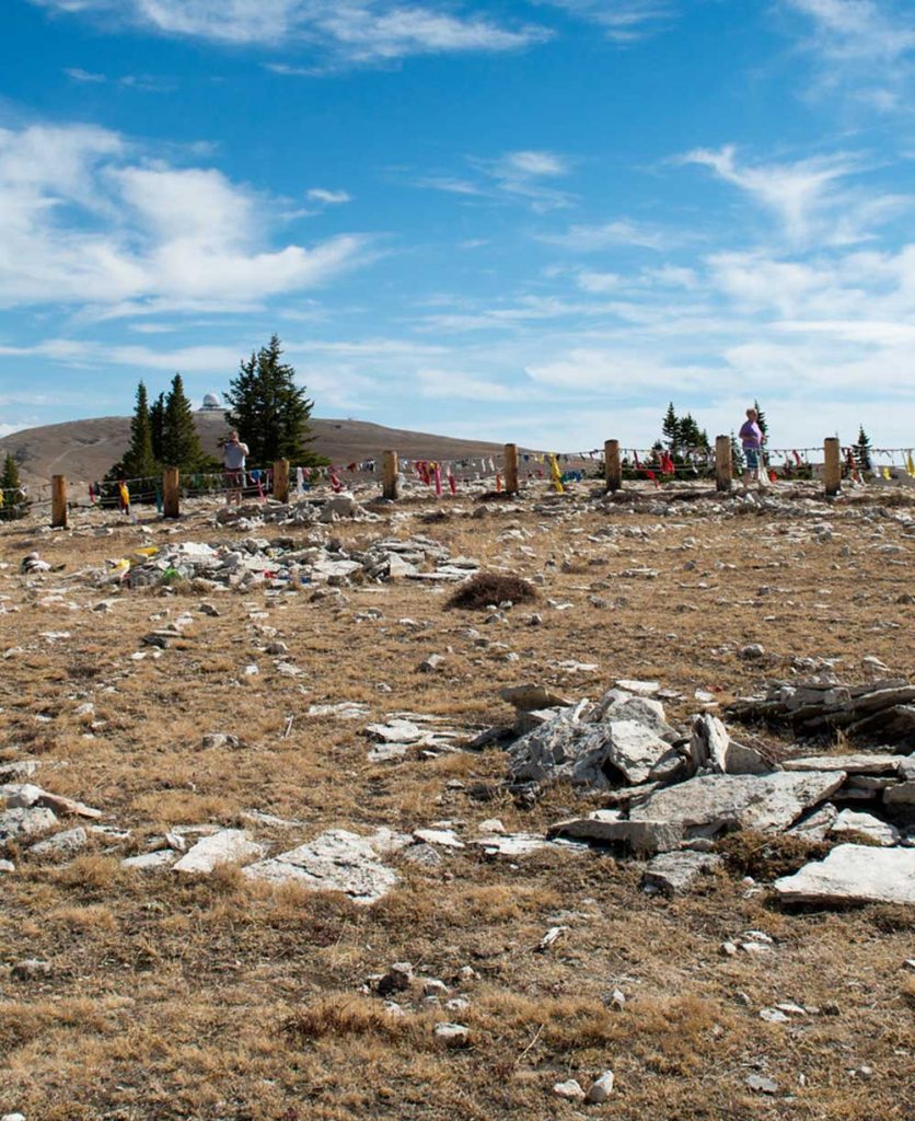 The rocks at Medicine Wheel establishing a wheel pattern in a grassy landscape in Wyoming.