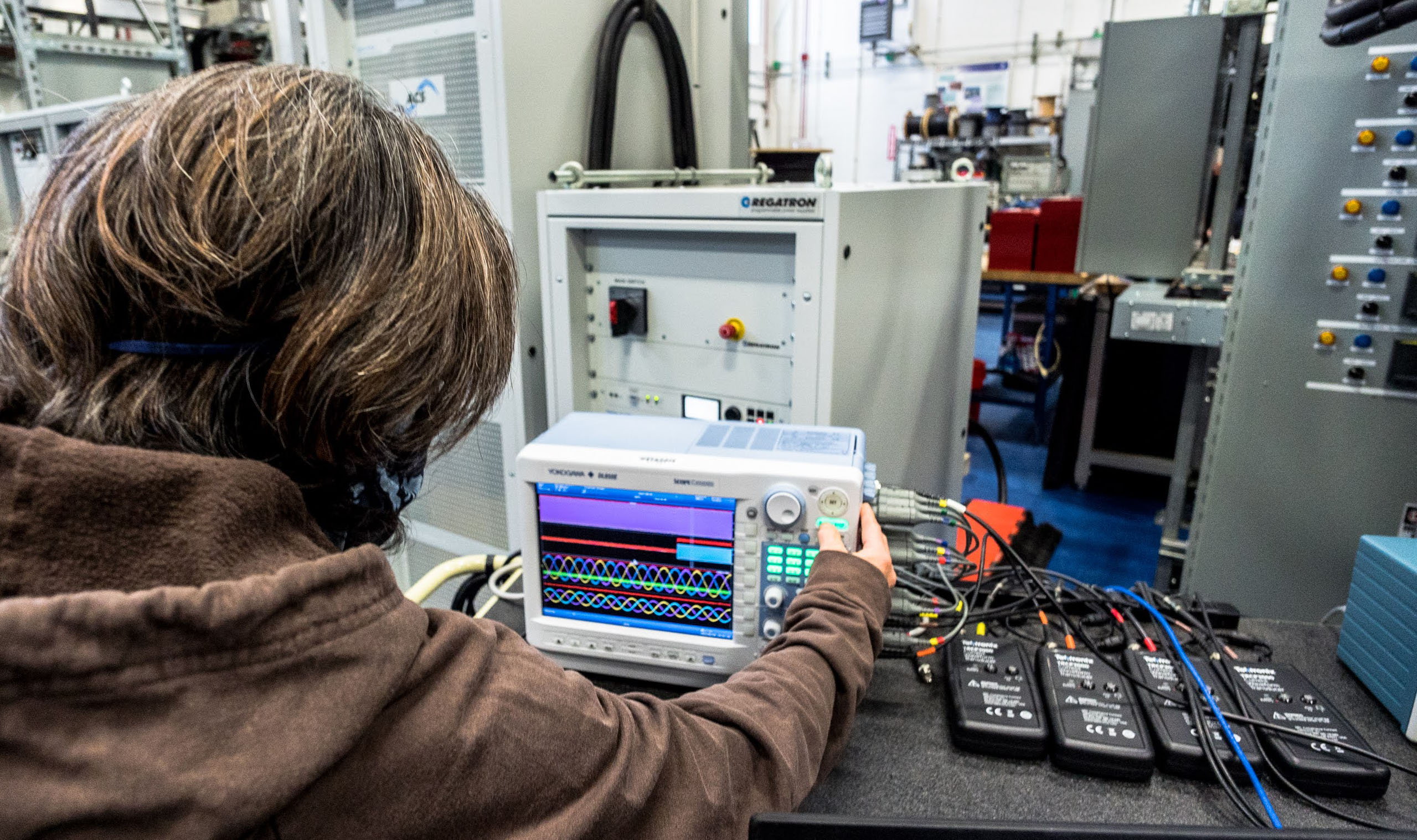 Woman works with electrical equipment in a University of Alaska Fairbanks research lab.