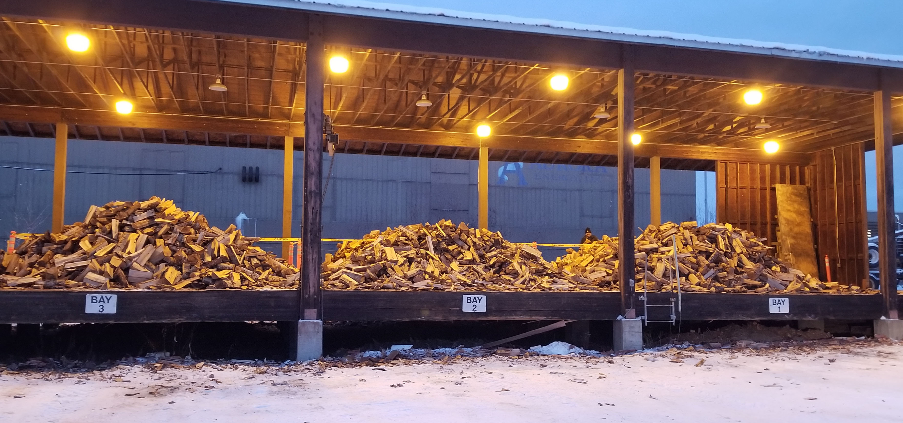 Wood sits in three piles on a platform