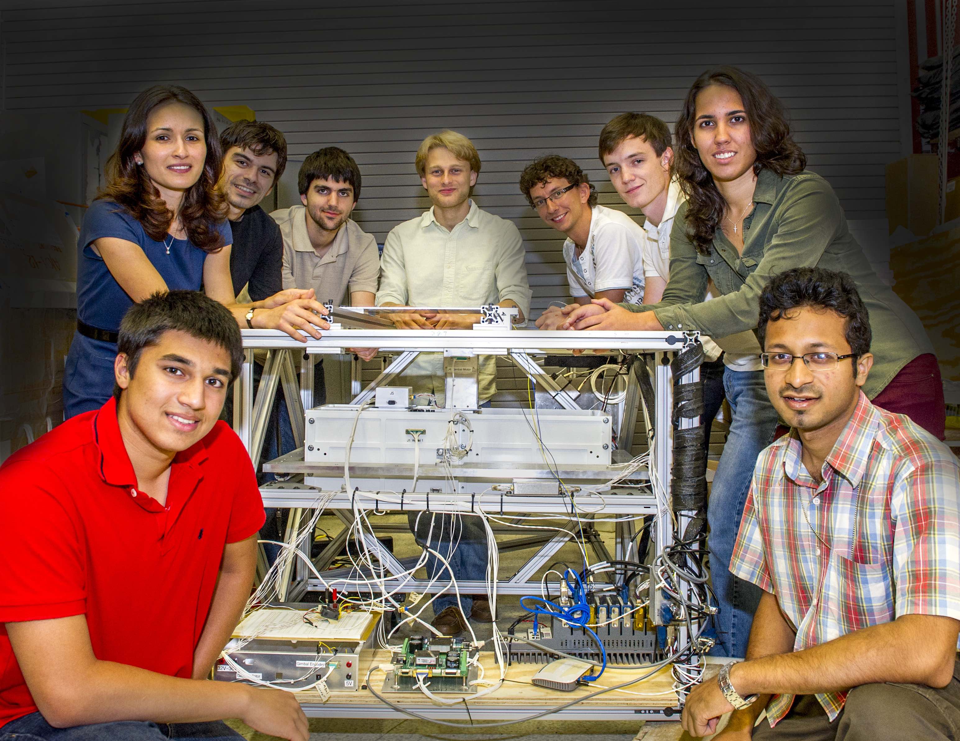 NASA Goddard Space Flight Center student interns pose with BETTI, the Balloon Experimental Twin Telescope for Infrared Interferometry.