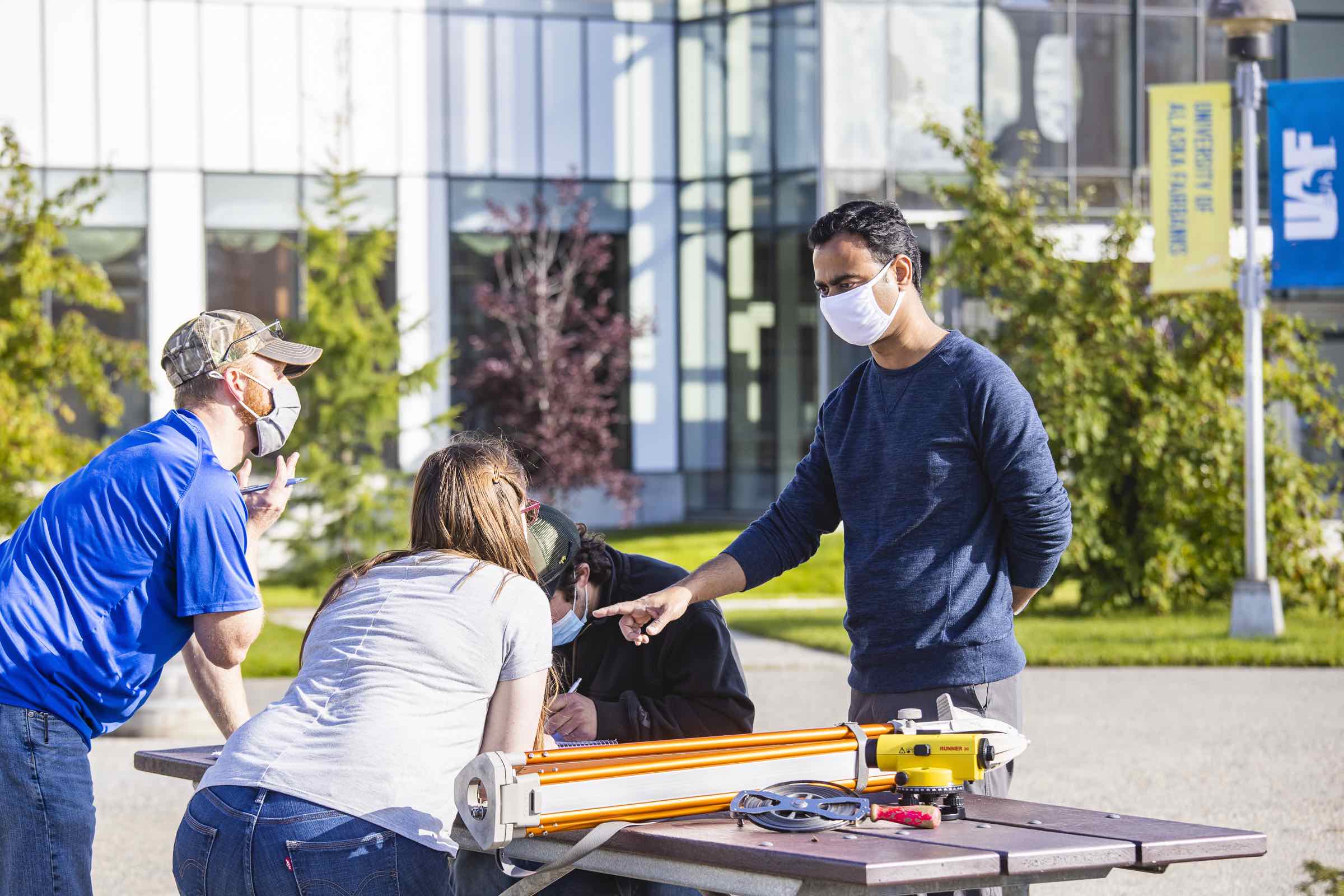 students standing over a table