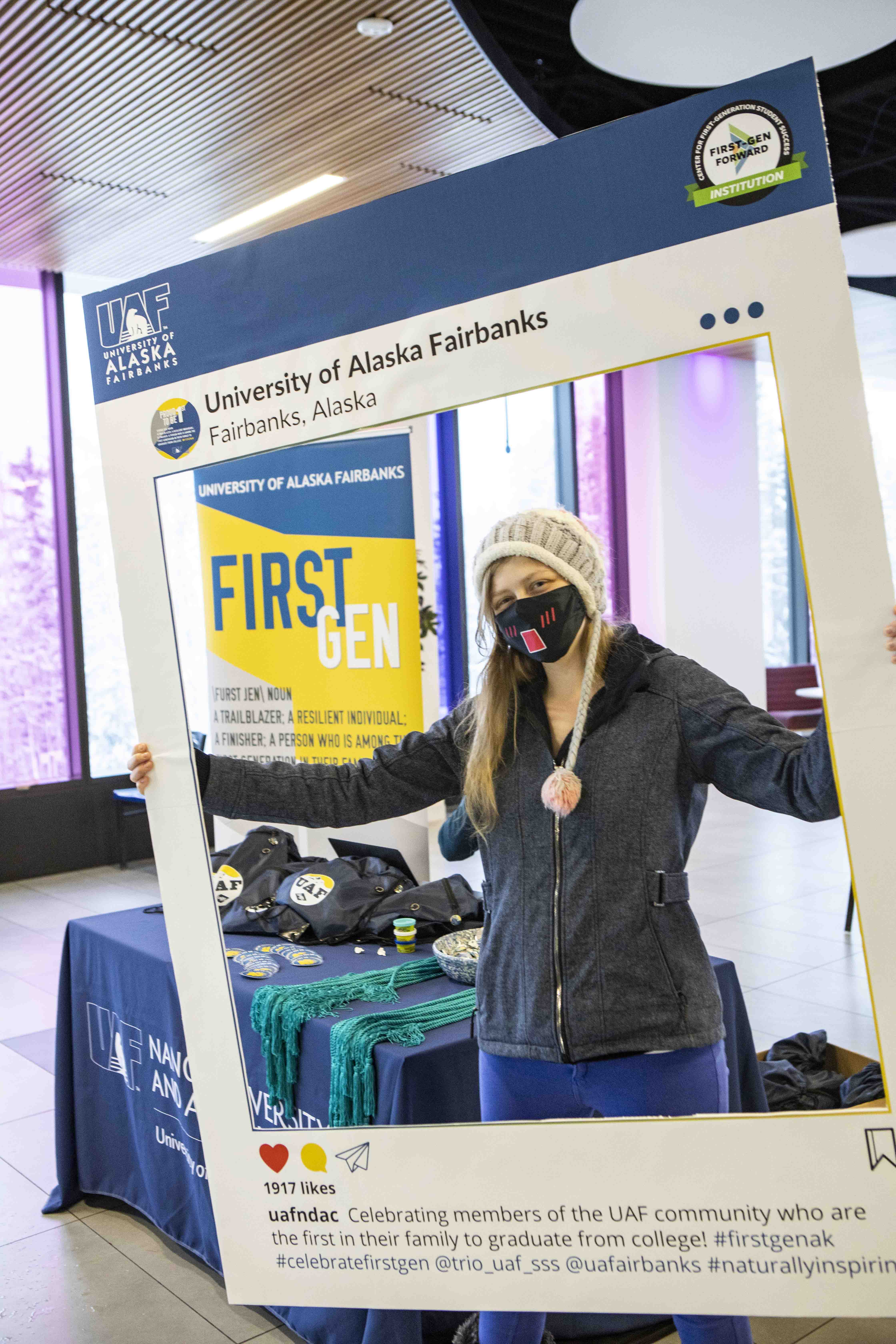 masked student holding a graduation frame