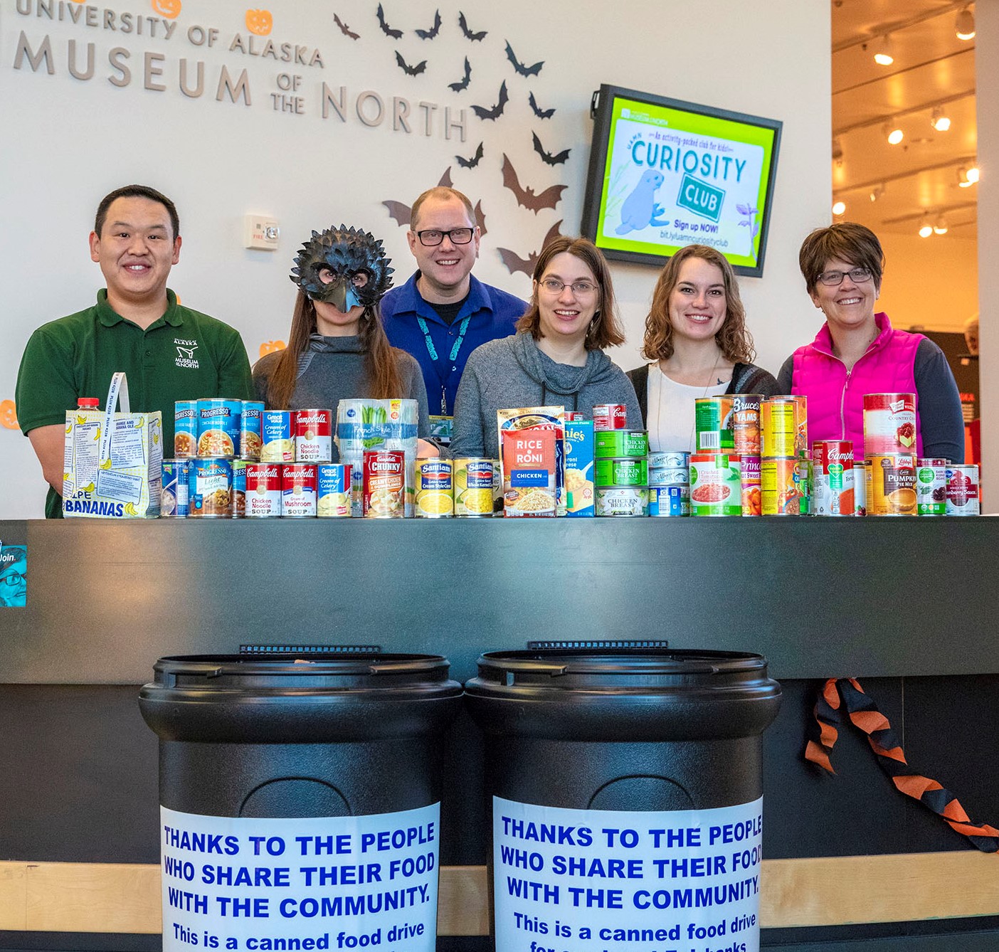 people at a table filled with nonperishable food