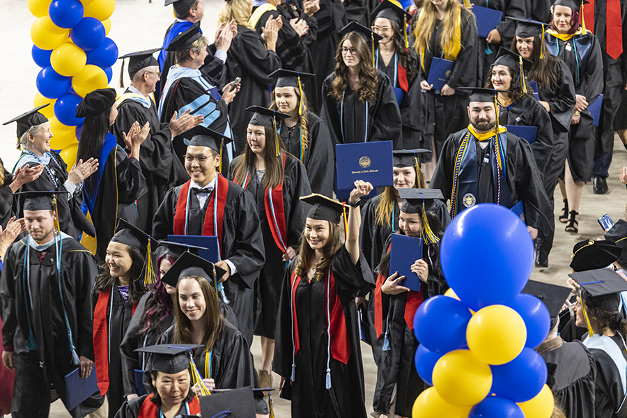 UAF graduates celebrate receiving their degrees on April 30, 2022, at the Carlson Center in Fairbanks. UAF/GI photo by JR Ancheta.