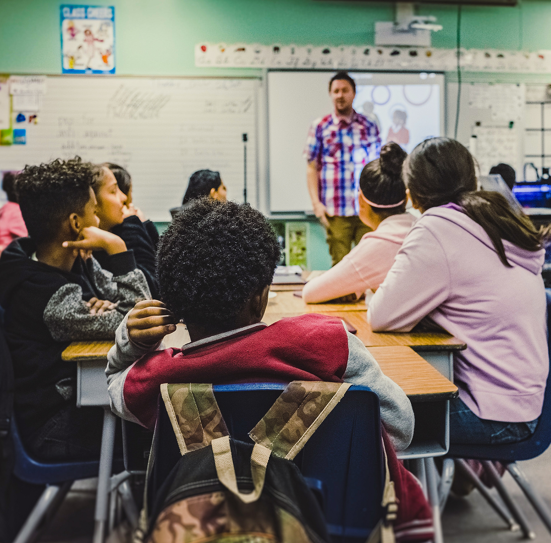 Students and teacher in an elementary classroom.