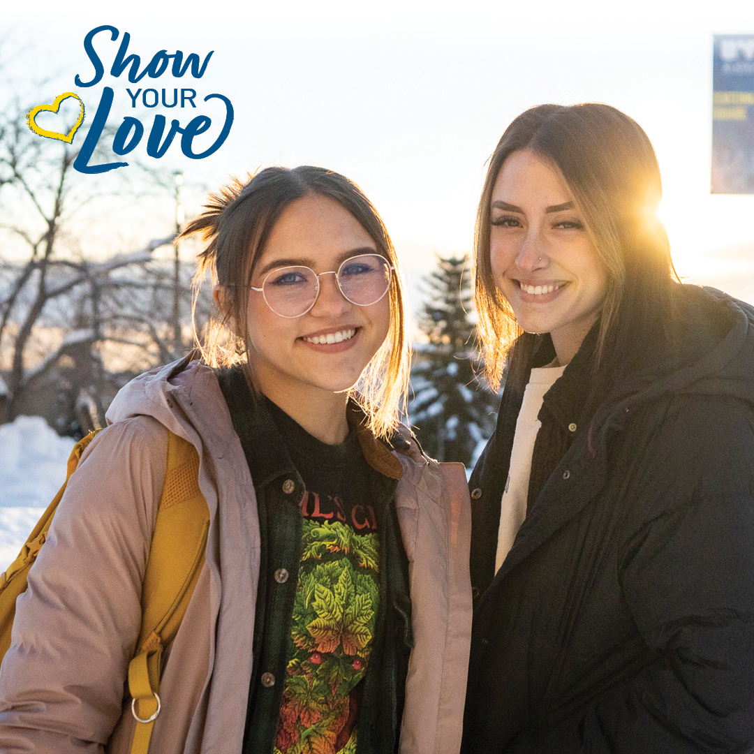 two women smile at the camera