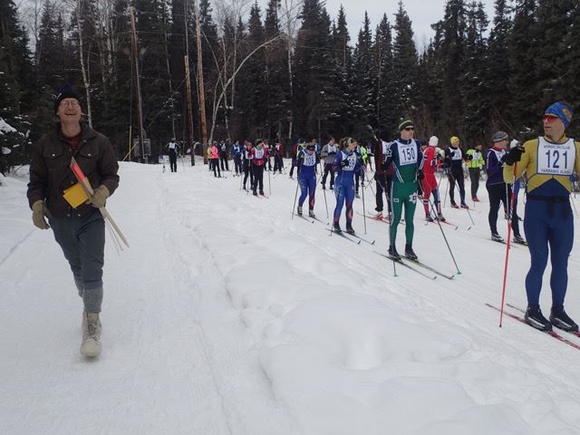 Stan Justice, left, prepares to signal skiers to begin the Skiathon during an event year prior to the COVID-19 pandemic. During the past two years, racers competed on their own during a weekend window. This year's race will again be a mass start.