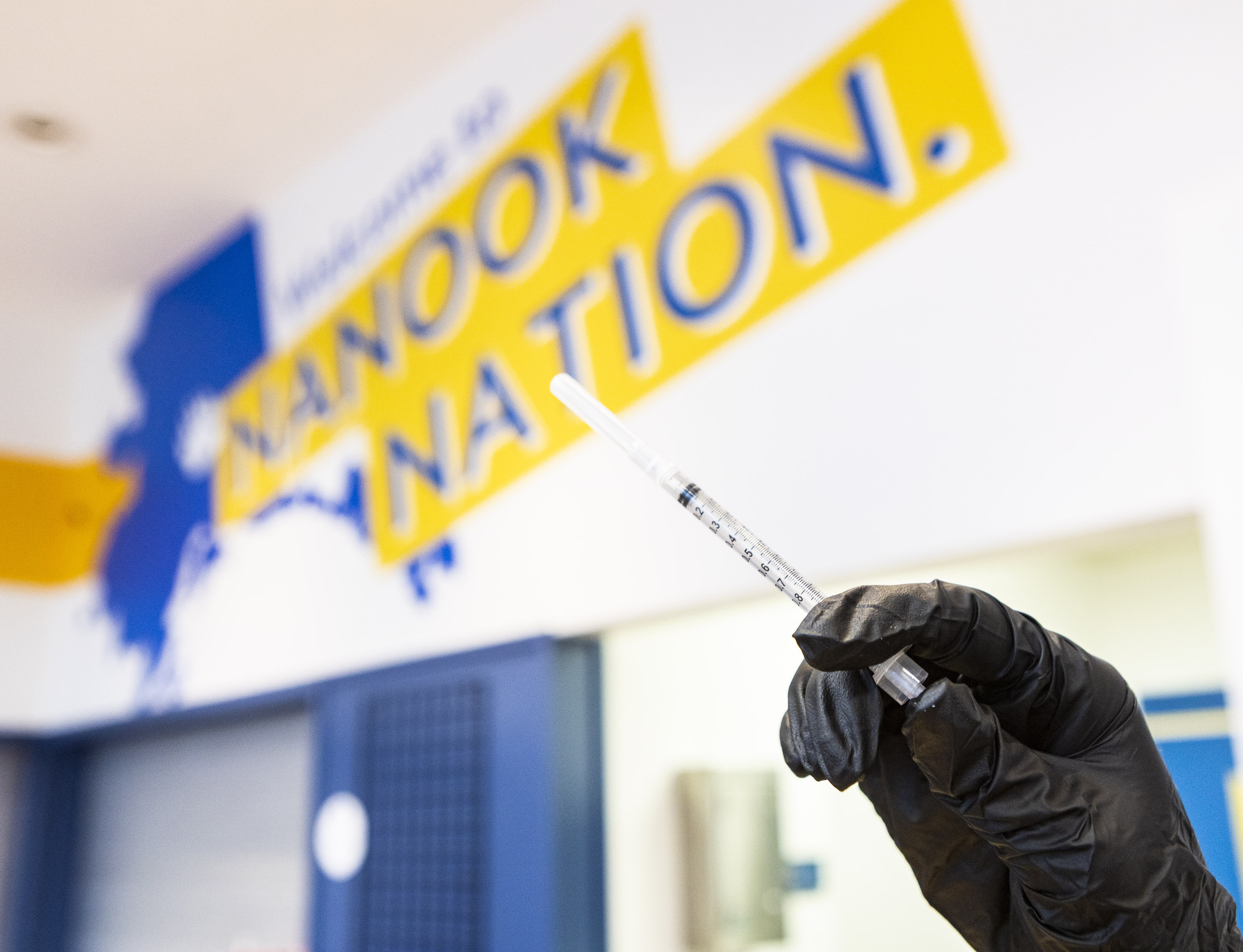 UAF photo by JR Ancheta
An employee at an on-campus vaccination clinic holds a syringe.