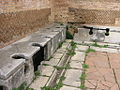 Image 43Public toilets (latrinae) from Ostia Antica (from Roman Empire)