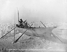 Man in a native whaling boat on an ice floe, with fishing spears, oars, and sealskin float, Bering Strait, Alaska, circa 1906 (AL+CA 2377).jpg