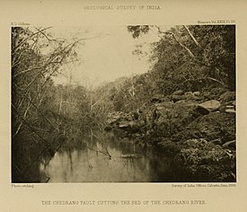 The Chedrang fault cutting the bed of the Chedrang River. The fault face forms the right bank of the current watercourse, and part of the former bed of the river can be seen above the fault face.