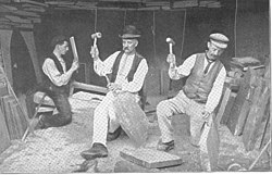 Splitting of the slate blocks with hammer and chisel to produce roofing slates requires great skill. This process was not mechanized until the second half of the 20th century, and some slate is still produced in this way. These quarrymen are working at the Dinorwic Quarry, Wales, about 1910.