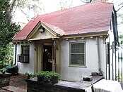 The cottage, a one-story structure with a red roof