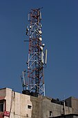 B4 India has the world's second-largest mobile phone user base of 996.66 million users as of September 2015[update]. Shown here is a rooftop mobile phone tower in Bangalore