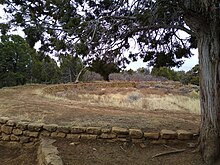 A color picture of a long curved brick structure