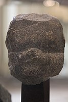 Fragment of the statue of a devotee, with inscription in the name of Naram-Sin: "To the god Erra, for the life of Naram-Sin, the powerful, his companion, the king of the four regions, Shu'astakkal, the scribe, the majordomo, has dedicated his statue".[122]