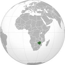 An orthographic projection of the world, centred on the Congo. Political borders are marked. Rhodesia (modern Zimbabwe) is highlighted in green.