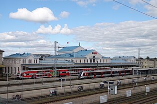 A large railway station with two trains