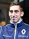 Sébastien Buemi in a blue jacket waving to a crowd