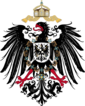 Shield containing a black, one-headed, rightward-looking eagle with red beak, tongue and claws. On its breast is a shield with another eagle. Over its head is an imperial crown with two crossing ribbons.