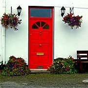 Ballyvaghan B^B - White Wall ^ Red Door with Lanterns ^ Flowers at Both Sides - geograph.org.uk - 3771813.jpg