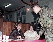 Berry signs autographs for US soldiers at Tuzla Main Base, Bosnia-Herzegovina (24 December 1996)