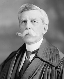 Photograph of Justice Oliver Wendell Holmes, aged about 89, in the robes of a judge