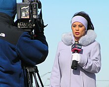 Image of a journalist from CN8 reporting from a scene