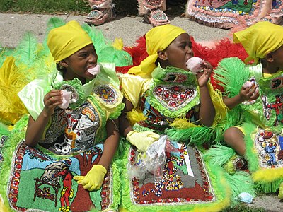 Girls dressed up for a parade wear matching yellow headscarves. 2009, New Orleans, Louisiana.