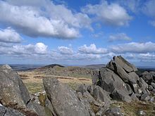 grey stone blocks in the foreground and hills in the background