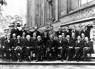 Fifth Conference, 1927. 1st row : Langmuir, Planck, Madame Curie, Lorentz, Einstein, Langevin, Guye, Wilson, Richardson. 2nd row : Debye, Knudsen, W. L. Bragg, Kramers, Dirac, Compton, de Broglie, Born, Bohr. 3rd row : Piccard, Henriot, Ehrenfest, Herzen, de Donder, Schrödinger, Verschaffelt, Pauli, Heisenberg, Fowler, Brillouin.