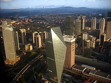 Skyline of a portion of the city, including several skyscrapers interspersed among low- and mid-rises, several historic buildings, parks and hilly terrain, and the waterway known as Bosphorus