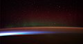 Image 13Earth's night-side upper atmosphere appearing from the bottom as bands of afterglow illuminating the troposphere in orange with silhouettes of clouds, and the stratosphere in white and blue. Next the mesosphere (pink area) extends to the orange and faintly green line of the lowest airglow, at about one hundred kilometers at the edge of space and the lower edge of the thermosphere (invisible). Continuing with green and red bands of aurorae stretching over several hundred kilometers. (from Earth)