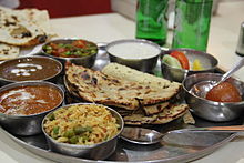 Punjabi style vegetarian thali served in a restaurant.