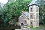 a brick boathouse with a tower