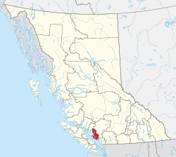 A map of British Columbia depicting its 29 regional districts and equivalent municipalities. One is highlighted in red.